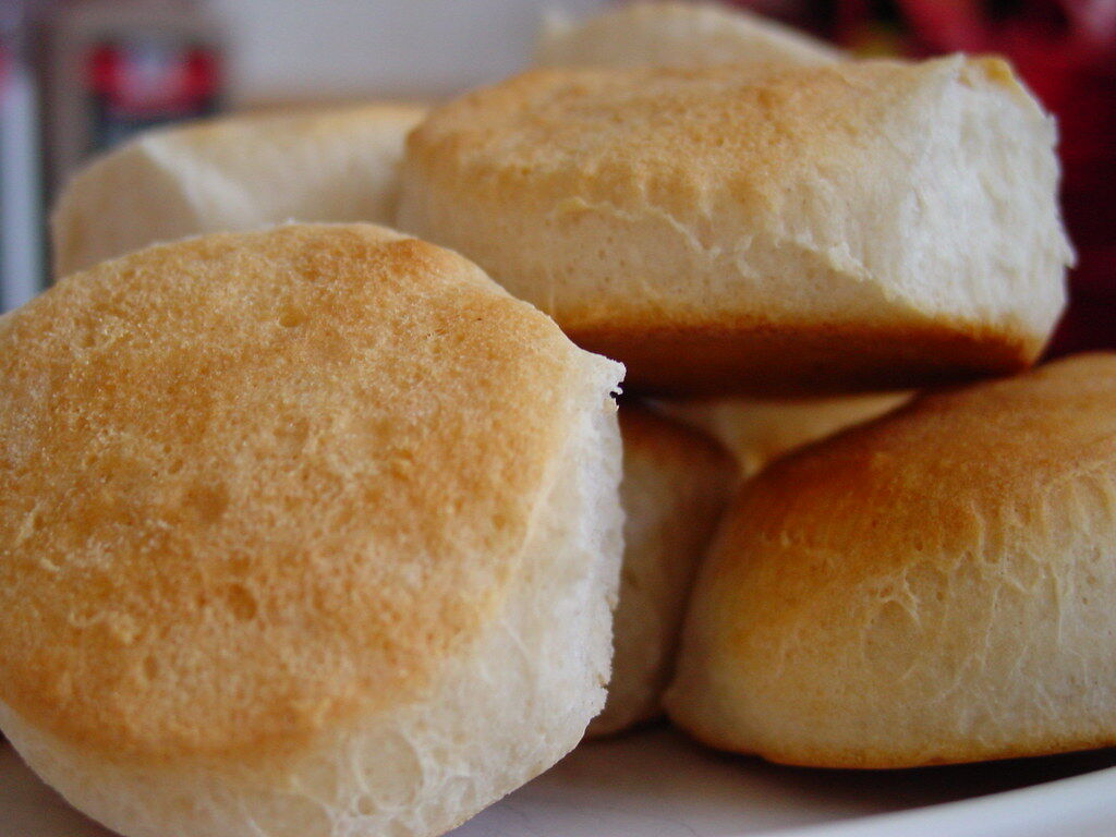 Fluffy homemade biscuits, one split to show its airy inside