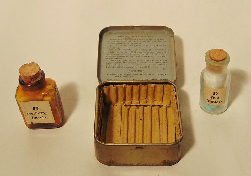 Old military tins and bottles of water purification tablets