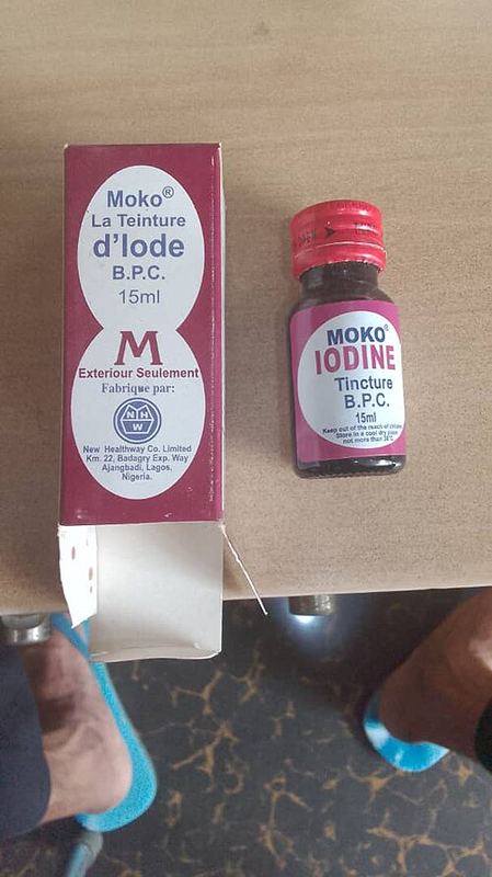 A small brown bottle of iodine tincture next to its box