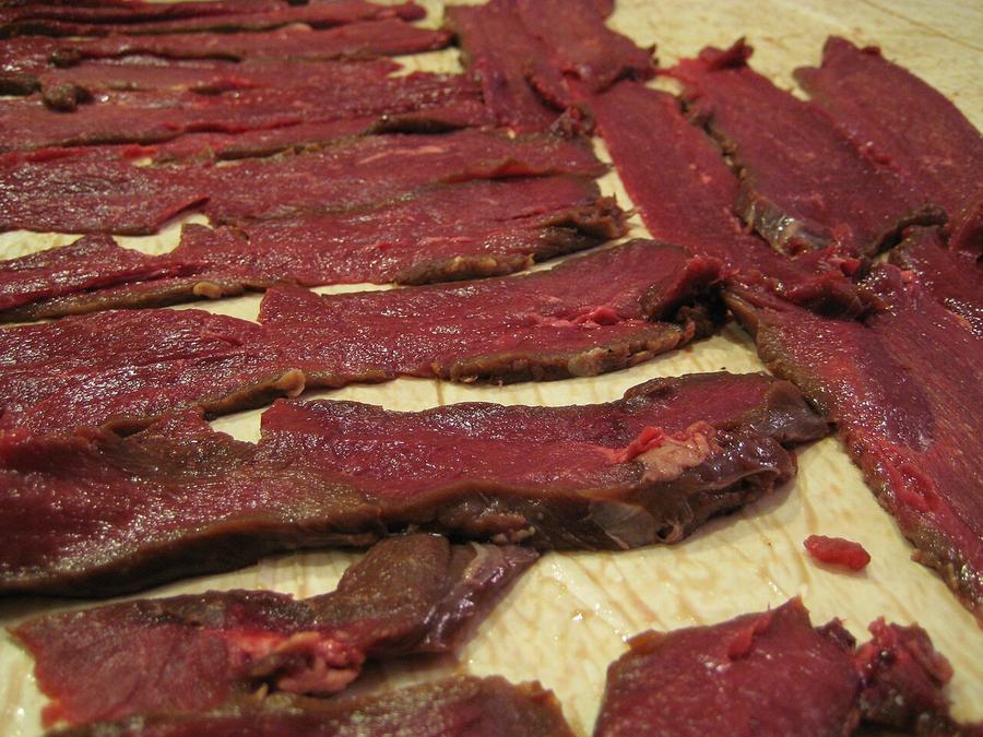 Thin strips of venison laid out before drying