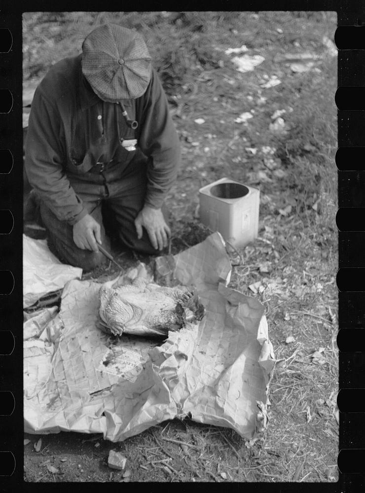 Old photo of a man killing a turtle to make soup